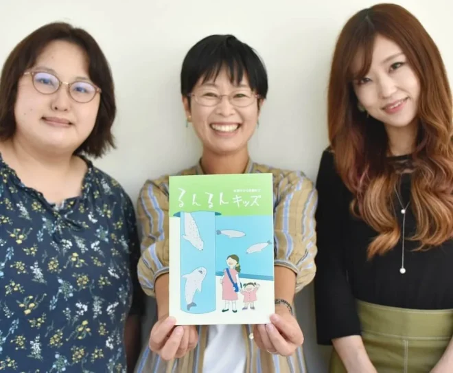 妊娠中から入園までの情報をまとめた冊子「るんるんキッズ」を製作した佐々木響子さん(中央)ら